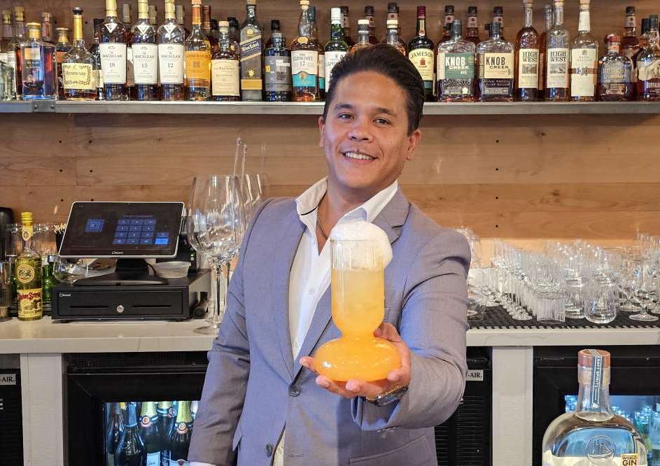 Nick Pauda holds Citronette Cocktail at Course Restaurant